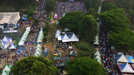 Drone-rising-over-people-and-tents-at-the-Yafe-Yaounde-Festival-in-sunny-Cameroon