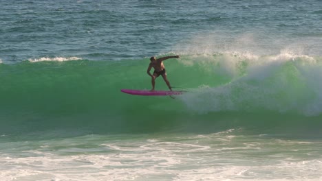Surfer-enjoying-the-waves-on-a-longboard-on-a-sunny-day,-Burleigh-Heads,-Gold-Coast,-Australia