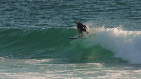 Surfers-enjoying-the-waves-on-a-sunny-day,-Burleigh-Heads,-Gold-Coast,-Australia