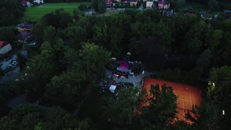 4k-Drone-View-of-Music-Stage-and-the-Crowd-in-Public-Park-at-Evening