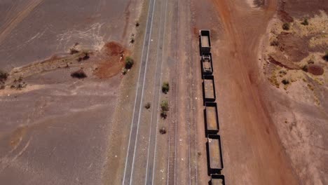 Drone-shot-of-an-old-iron-ore-train-parked-in-Zouérat,-Mauritania