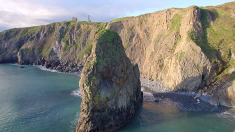 Drone-panning-left-around-stunning-rock-formation-on-The-Copper-Coast-Waterford-Ireland