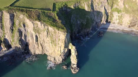 Drone-circling-dramatic-rock-formations-and-seascapes-Copper-Coast-Waterford-Ireland
