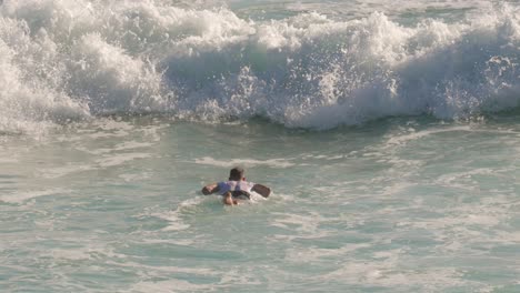 Surfer-paddling-out-and-enjoying-the-waves-on-a-sunny-day,-Burleigh-Heads,-Gold-Coast,-Australia