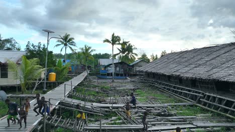 Poor-village-wooden-houses-location-in-tropical-area-landscape,-children-running