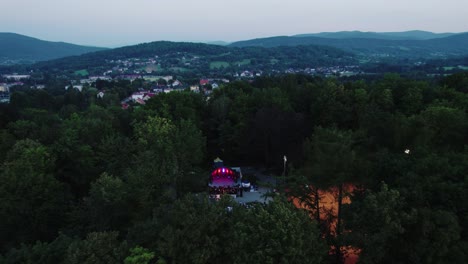 Drone-Shot-of-Music-Concert-on-the-Illuminated-Stage-and-Crowd-in-Public-Park-at-Evening