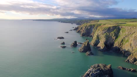 Drone-flying-along-dramatic-coast-with-cliffs-and-rock-formations-Copper-Coast-Waterford-Ireland