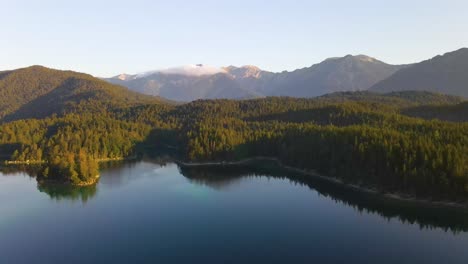 Aerial-Footage-Of-Lake-Eibsee-Beneath-Zugspitze-Peak-With-Small-Islands