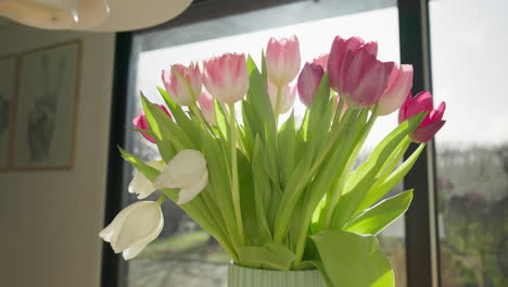 Fresh-tulips-in-vase-with-natural-light-in-sunlit-living-room