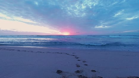 Colourful-Timelapse-of-Sunrise-on-Beach,-Waves-coming-in,-Clouds-going-out