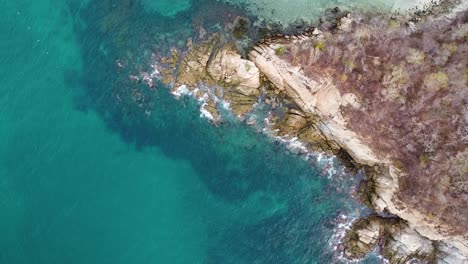 Rocky-peninsula-shoreline-with-turquoise-Pacific-water-in-Huatulco---Oaxaco-State,-Mexico