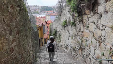 Woman-with-backpack-going-down-stairs-in-Escadas-do-Barrero