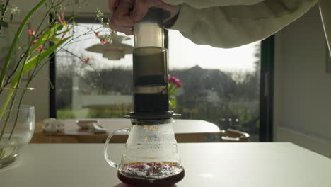 Hand-operated-coffee-press-in-a-sunlit-modern-kitchen