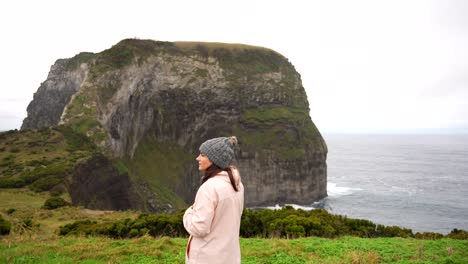 Woman-with-winter-clothes-in-Azores-looking-around-in-Morro-do-Castelo-Branco