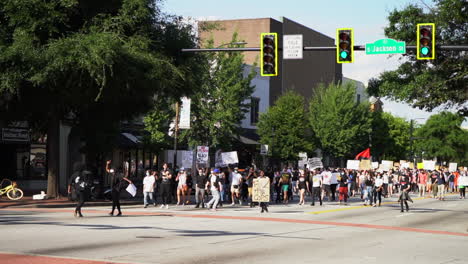 Black-lives-matter-protestors-marching-down-the-city-streets-with-signs-in-peaceful-rally