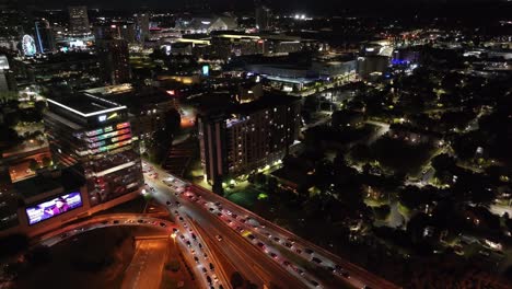 Drone-shot-of-Downtown-Atlanta-city-traffic-at-night,-Georgia