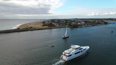 Aerial-view-around-a-yacht-and-sailboat-at-the-Newport-Beach,-in-Los-Angeles,-USA