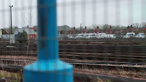 Rusty-Train-Tracks-with-Car-Park-in-Distance