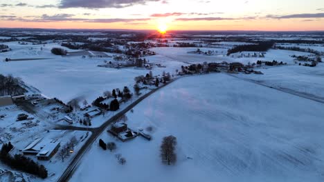High-and-wide-aerial-shot-of-rural-snow-covered-country-farmland-and-fields-in-USA