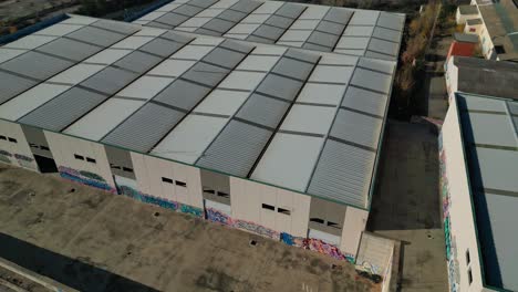 Industrial-warehouse-roofs-near-Abrera,-Barcelona,-Spain,-aerial-view