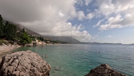 A-Time-Lapse-of-a-Beach-Scene-on-a-Croatian-Beach-with-the-Clouds-Moving-and-People-Enjoying-the-Beach