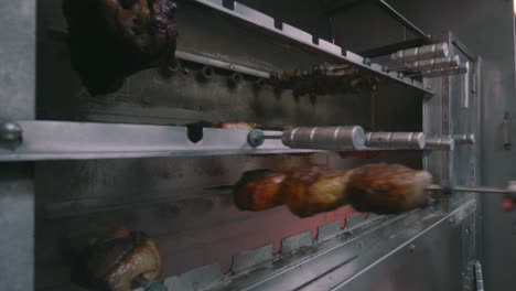 Meats-being-cooked-Rotisserie-style-in-restaurant-oven