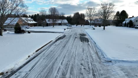Drone-flies-along-icy-snow-covered-street-in-USA-toward-cul-de-sac-dead-end
