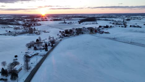 Wide-high-aerial-of-sunrise-in-winter-snow