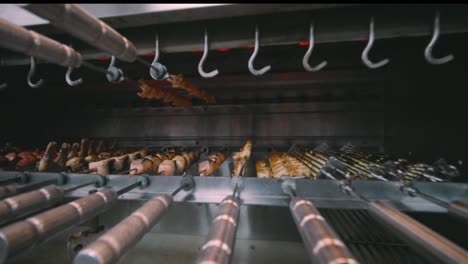 Variety-of-Meats-being-cooked-Rotisserie-style-in-restaurant-oven