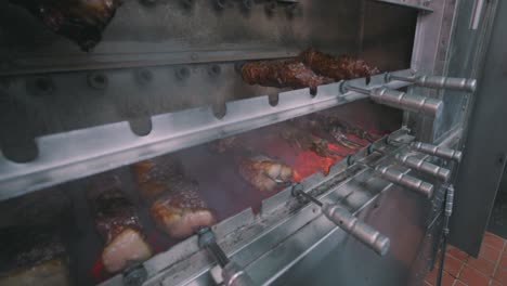 Meats-being-cooked-Rotisserie-style-in-restaurant-oven