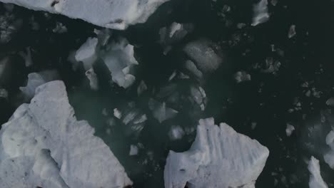Iceberg-Melting-from-Iceland-Glacier,-Cinematic-Top-Down-Aerial-View