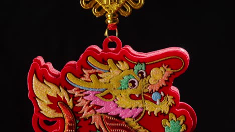 Close-shot-of-a-dragon-pendant,-Chinese-new-year-decoration,-isolated-background