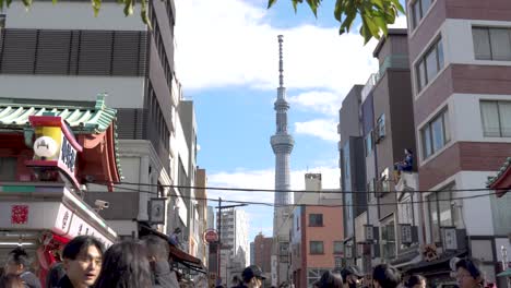 Crowded-street-view-of-Tokyo-Skytree-among-buildings-in-Japan,-clear-day