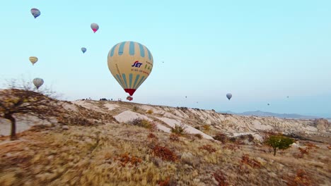 Hot-Air-Balloons-Rising-Above-Mountains-In-Cappadocia,-Turkey-At-Sunrise
