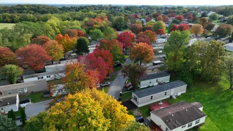Aerial-view-of-a-mobile-home-park-with-colorful-autumn-trees-and-green-fields
