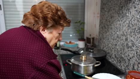 Elderly-woman-preparing-to-cook-in-kitchen,-4K