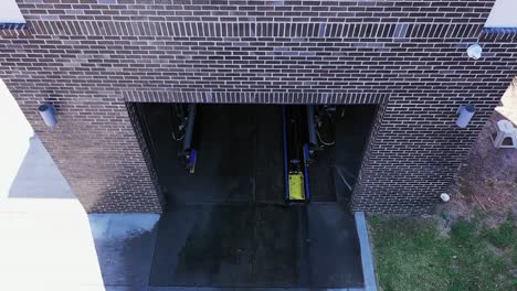 Cinematic-Drone-View-of-Carwash-Exit,-Jeep-and-GMC-Vehicles