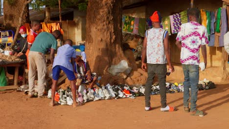 local-vendor-at-local-market-stand-selling-traditional-tribe-clothing-in-west-Africa