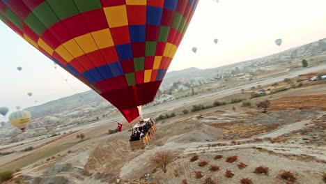 Drone-Flying-Around-Tourists-Enjoying-Ride-In-Hot-Air-Balloon-Basket-In-Cappadocia,-Turkey