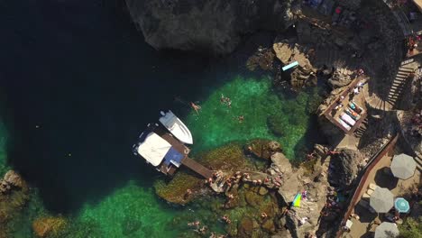 Summer-holiday-fun-water-activities-Corfu-island-idyllic-rocky-bay-TOP-DOWN