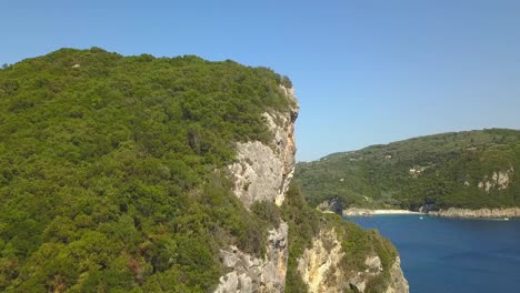 Cinematic-Corfu-headland-flyover-reveals-beautiful-Paleokastitsa-beach-resort