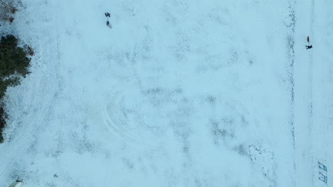 From-above,-the-snow-reveals-a-solitary-figure's-path,-a-visual-narrative-of-journey-and-the-subtle-interaction-between-human-and-the-expansive-winter-environment