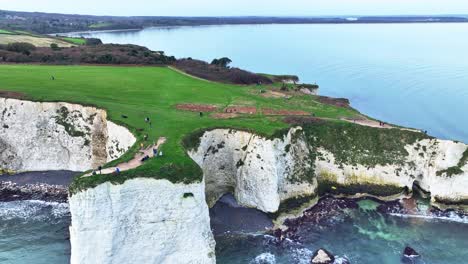 Aerial-View-panning-right-along-the-chalk-white-cliffs-at-Old-Harry-Rocks-England