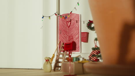 Dolly-in-on-Festive-Christmas-corner-with-a-red-door-and-seasonal-decorations