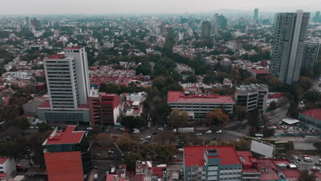 Drone-footage-of-Mexico-City-showcasing-highways,-streets,-cars,-homes,-and-distant-mountains-against-the-skyline