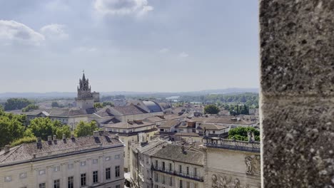 View-over-the-city-of-Avignon-in-France,-French-roofs-with-church-Avinon