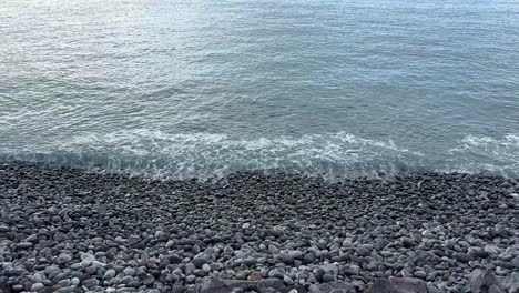 Slow-small-waves-into-pebble-stone-beach-in-Tenerife-Spain-Canary-Islands