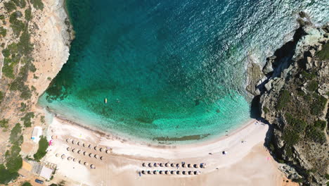 Aerial-drone-video-of-iconic-turquoise-and-sapphire-bay-and-beach-of-Andros,-Cyclades,-Greece