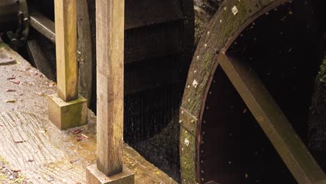 Close-up-on-the-bottom-section-of-two-hydraulic-wheels-from-a-water-mill
