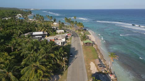 Aerial-Pull-Back-Shot-Of-Coastal-Road-Next-to-The-Caribbean